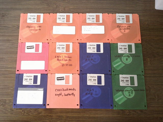 Some of the labeled floppy disks laid out on a desk